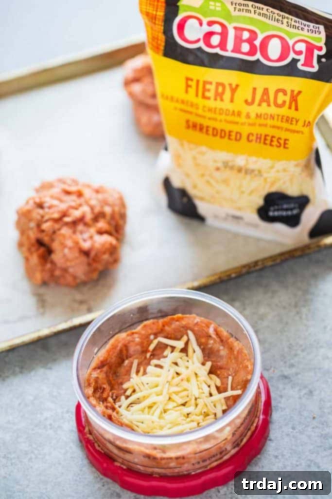A burger press being used to form a Chile Chorizo Burger patty, showing the step of adding cheese to the center