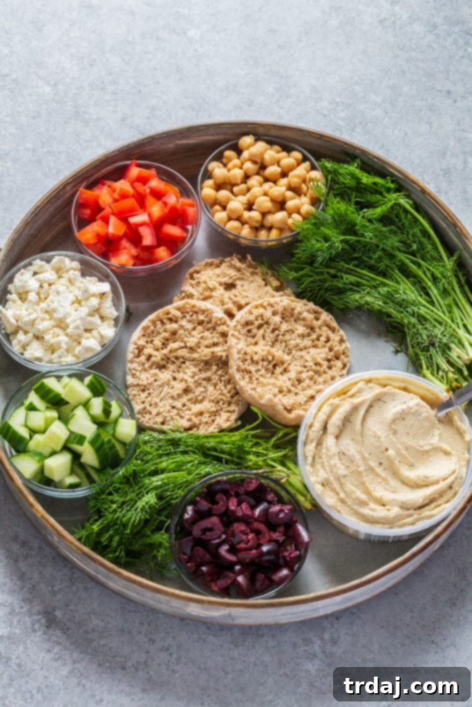 Ingredients to make Greek English Muffin Pizzas laid out