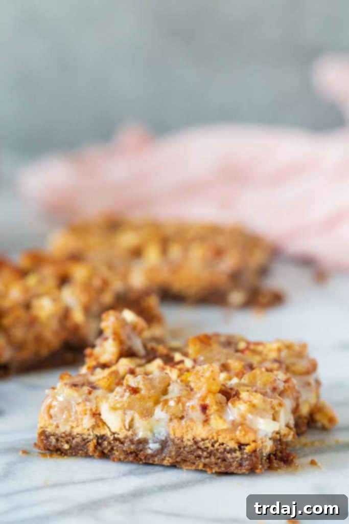 A stack of Apple Butterscotch Magic Bars on a wooden surface