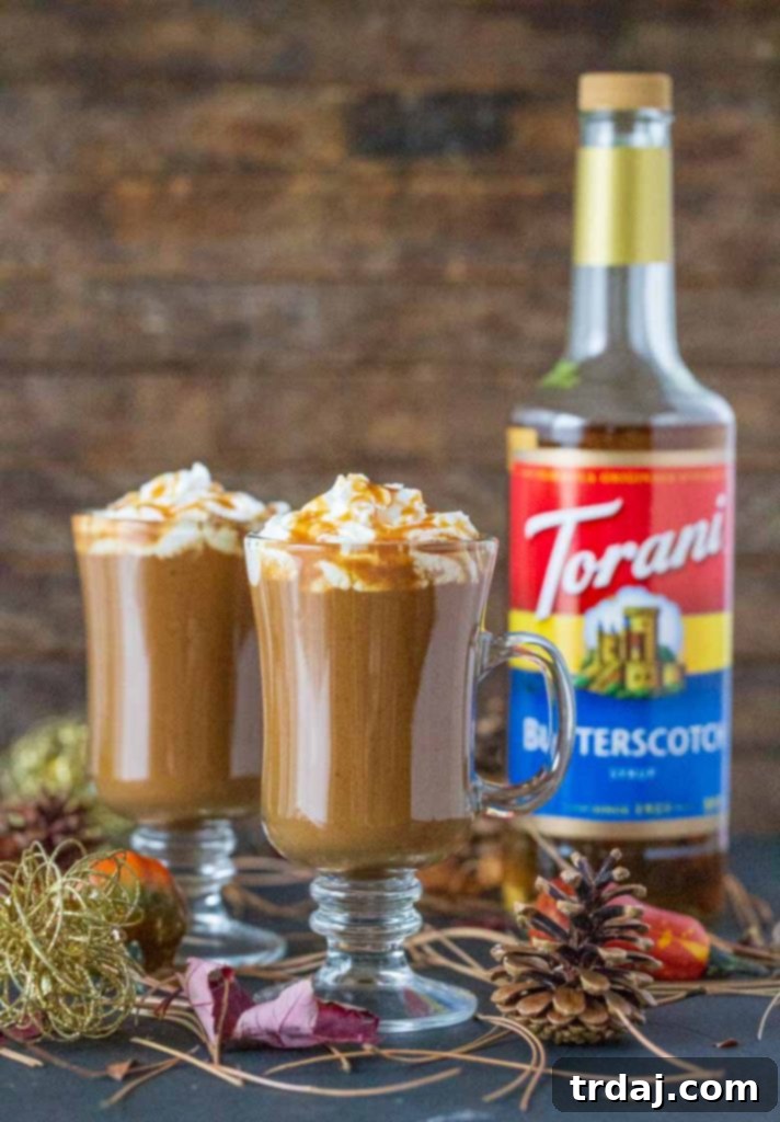 Close-up of a Butterscotch Pumpkin Spice Latte in a glass mug with whipped cream