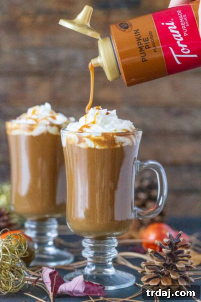 Warm Butterscotch Pumpkin Spice Latte with foamed milk and a sprinkle of spice