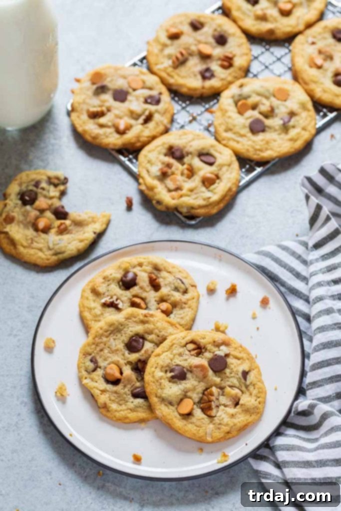 Irresistibly Chewy Seven Layer Cookies packed with chocolate, butterscotch, coconut, and pecans.