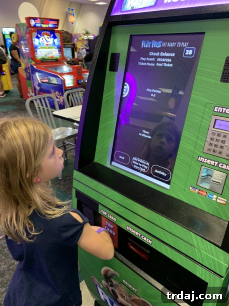 Child wearing an 'All You Can Play' wristband at Chuck E. Cheese arcade