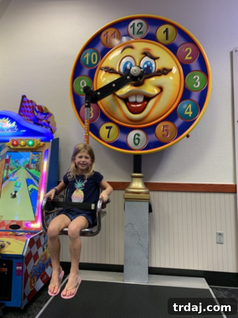 Daughter enjoying a classic clock ride at Chuck E. Cheese