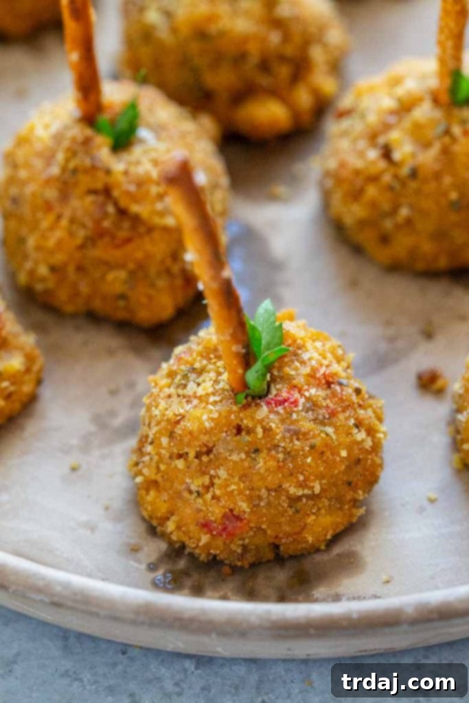 Close-up of baked Pumpkin Sausage Cheese Balls, showcasing their golden-brown exterior and delicious texture.