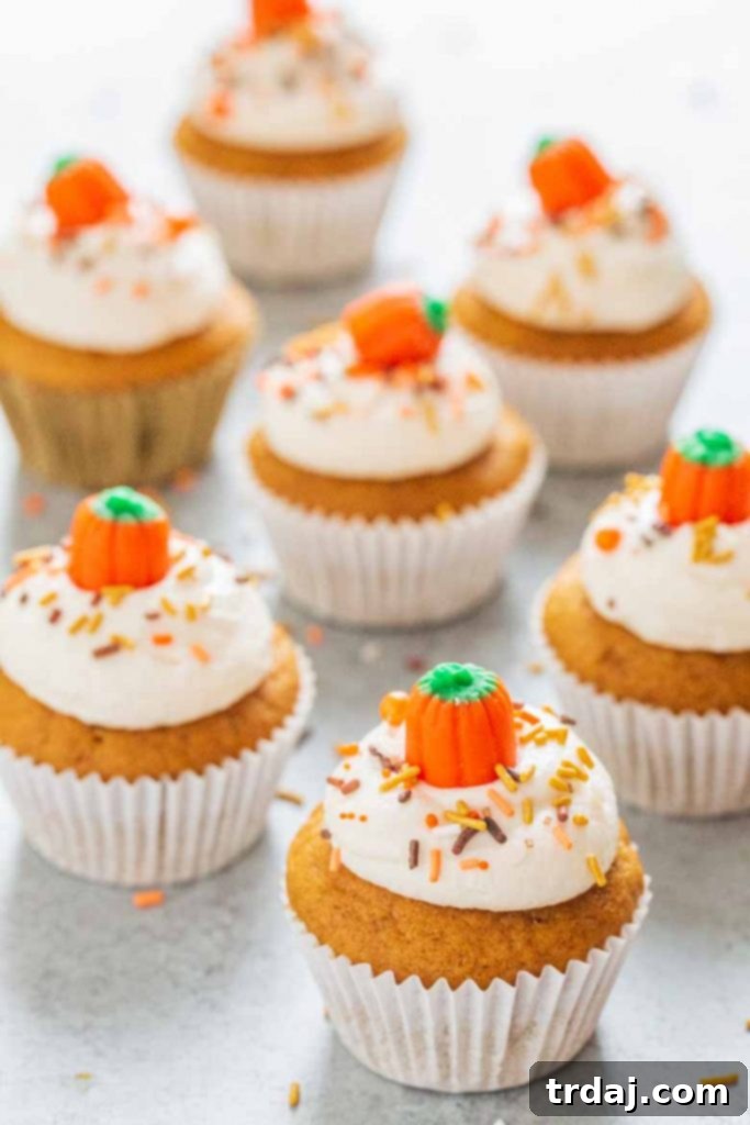 A close-up of a perfectly frosted pumpkin cupcake, showcasing its inviting texture.