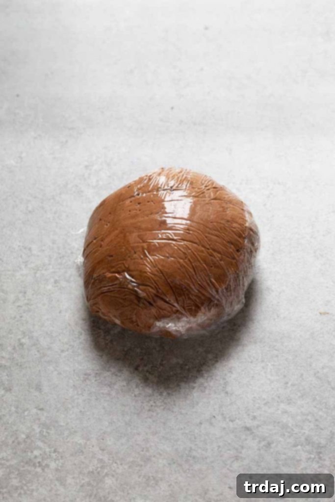 Death by Chocolate Dessert Ball Rolling the Death by Chocolate Dessert Ball tightly in plastic wrap before refrigerating to chill and firm up.