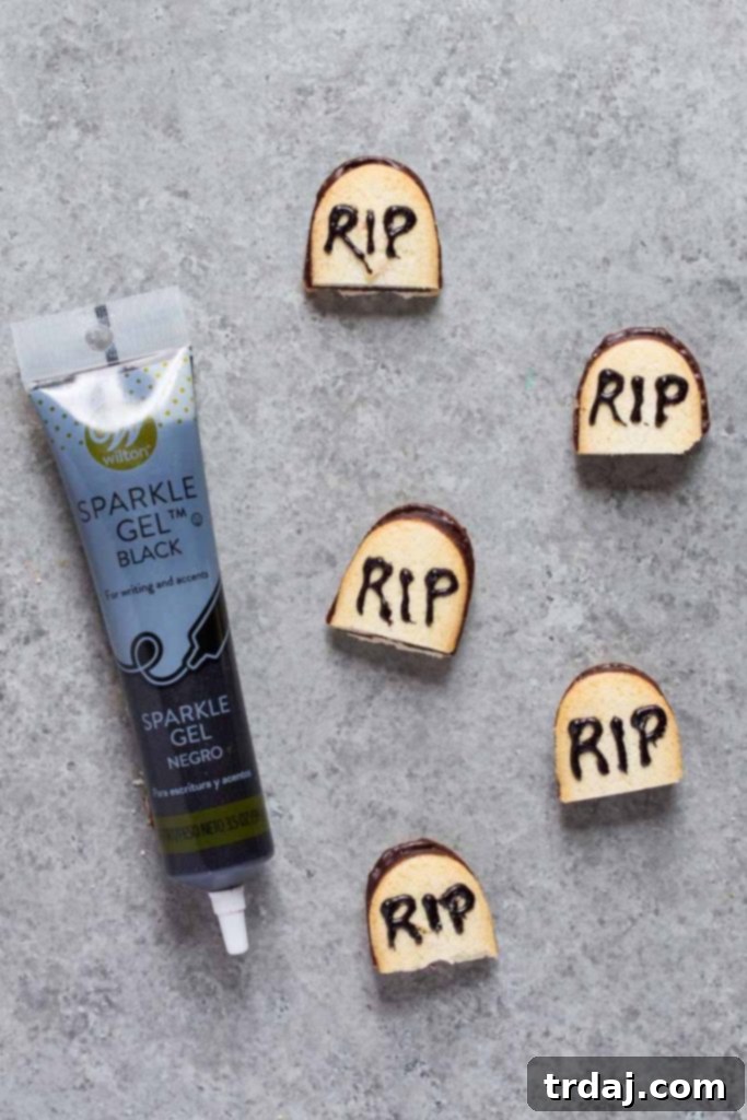 Death by Chocolate Cheese Ball Creating RIP gravestone cookies by slicing Milano cookies in half and writing 'RIP' with black food gel for a spooky Halloween touch.