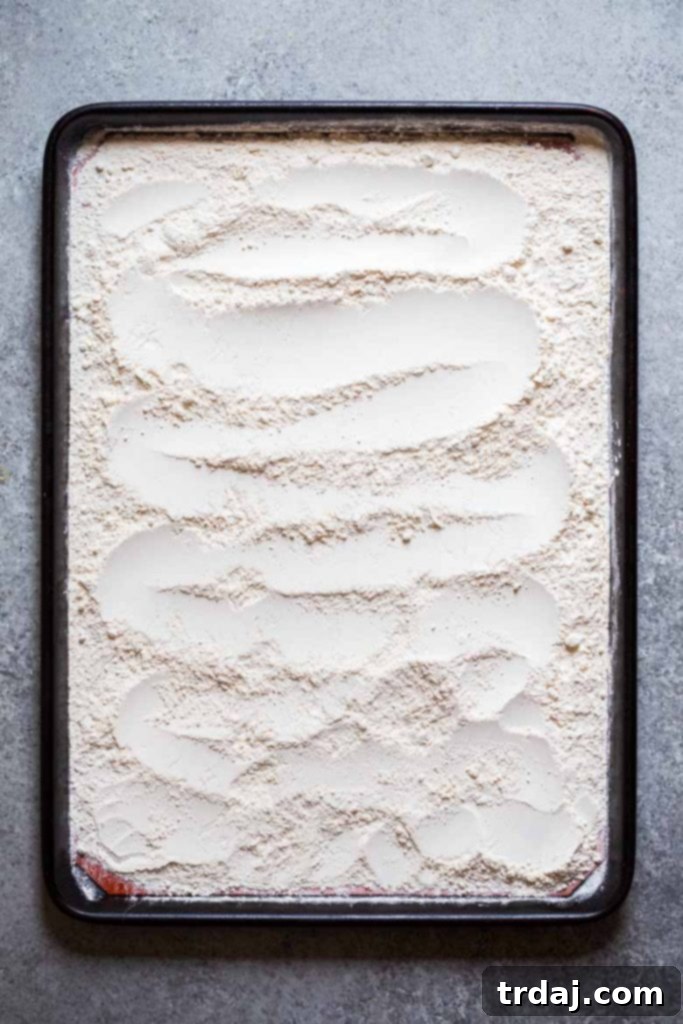 To cook raw flour, place raw flour onto baking sheet and bake in oven for 5 minutes 