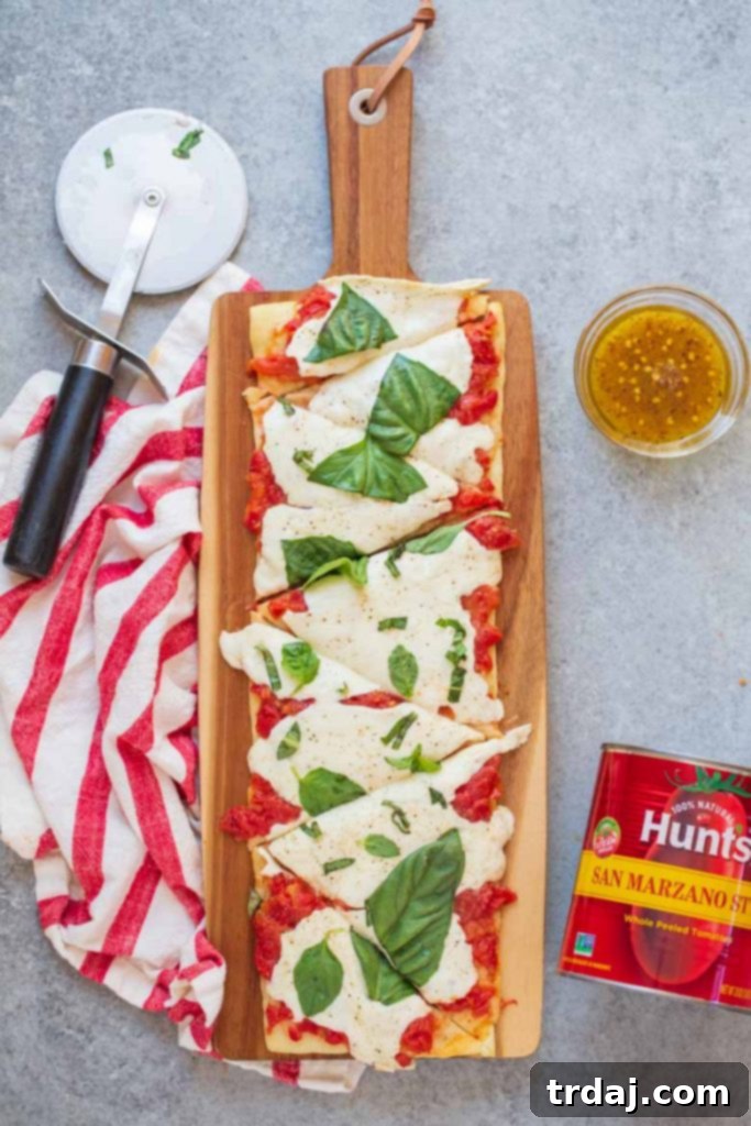 This Easy Margherita Flatbread Recipe is ready in under 20 minutes and thanks to Hunt's San Marzano style tomatoes, it's the freshest flatbread you'll get this side of Italy!