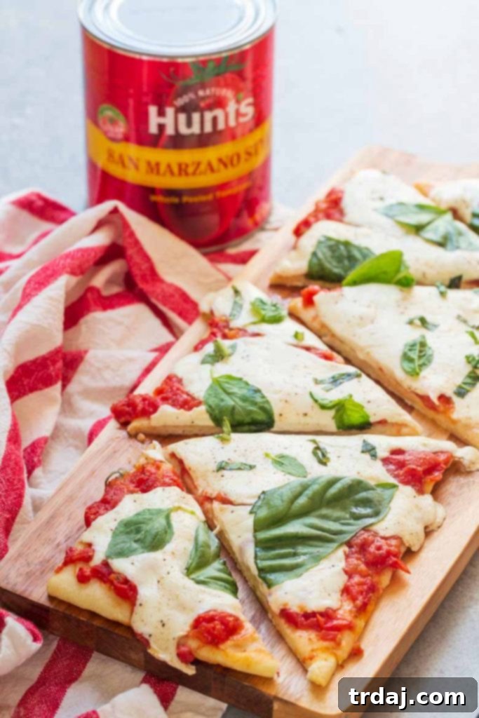 This Easy Margherita Flatbread Recipe is ready in under 20 minutes and thanks to Hunt's San Marzano style tomatoes, it's the freshest flatbread you'll get this side of Italy!