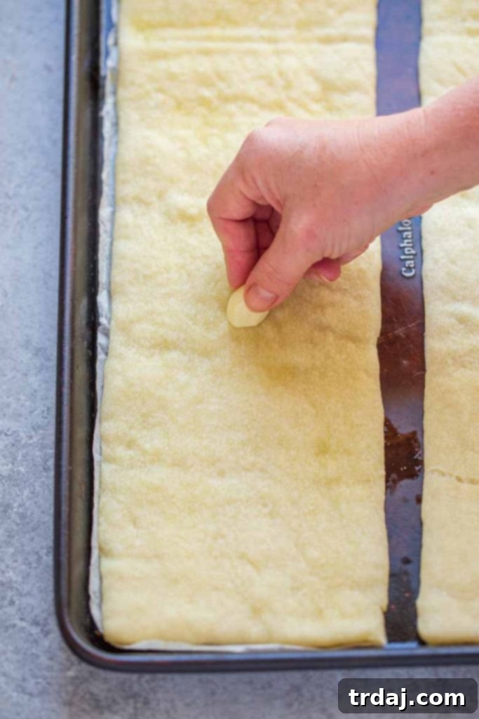 Rub garlic onto cooked pizza crust for Easy Margherita Flatbread Recipe