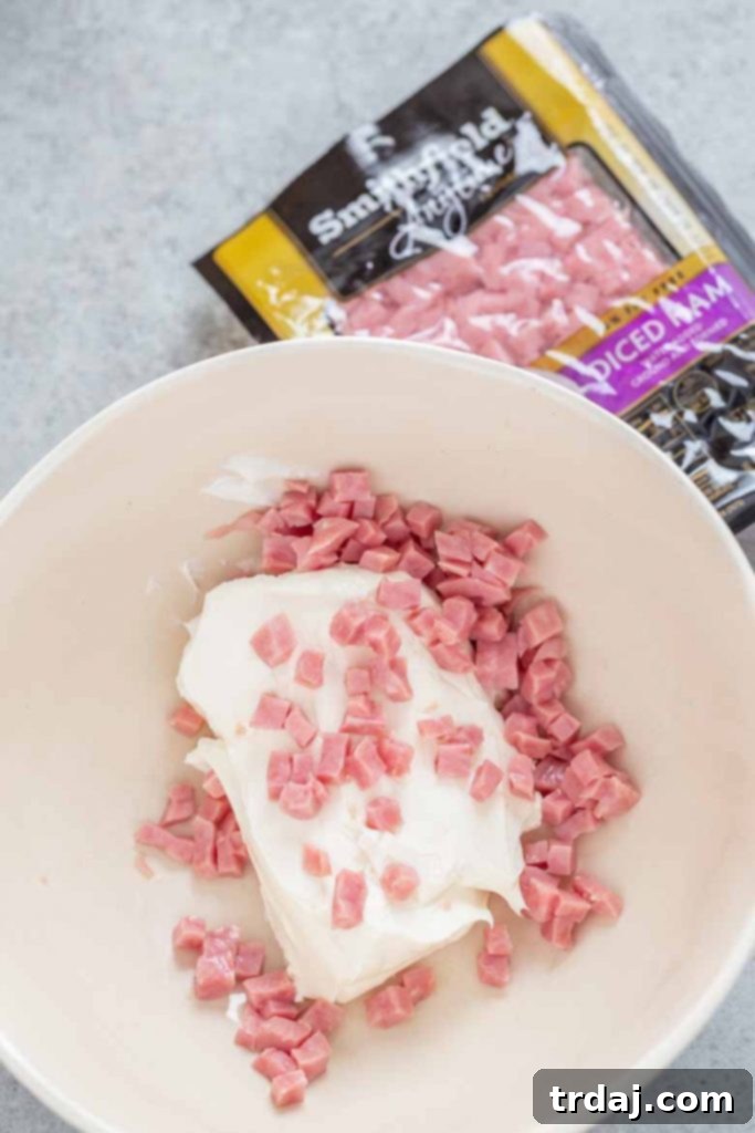 Mixing cream cheese and Smithfield Anytime Favorites Diced Ham for the stuffed potato filling