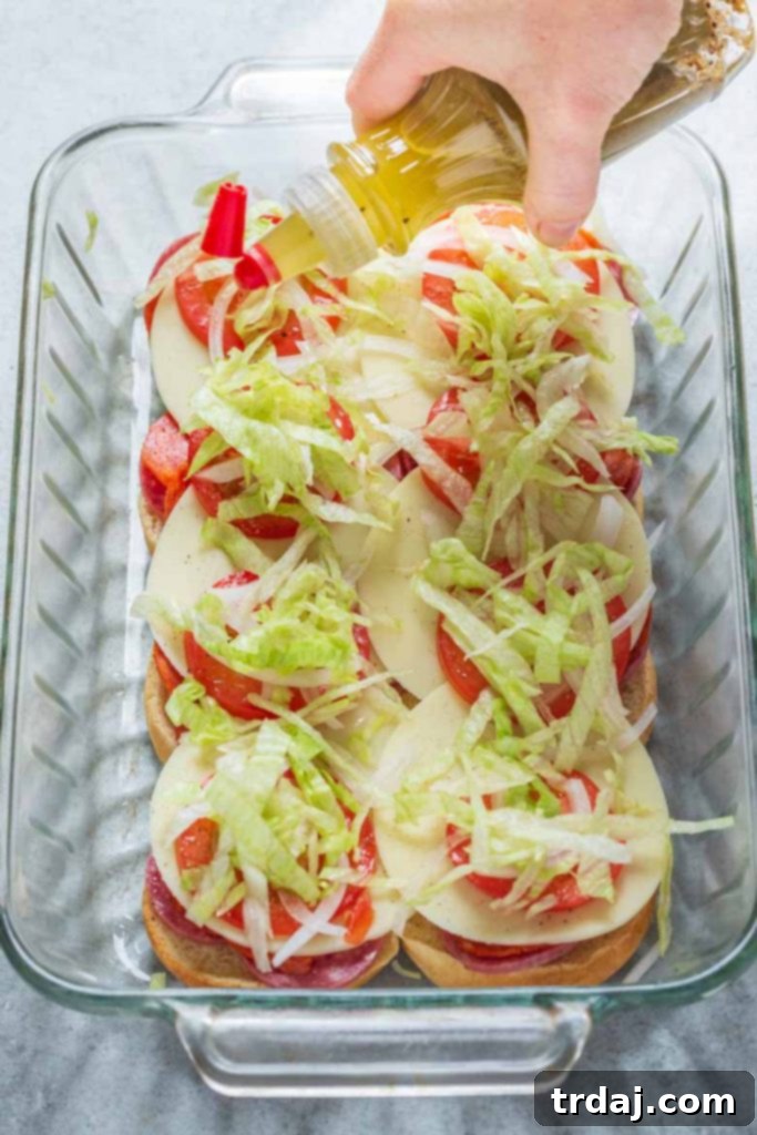 The finished Italian Sandwich Sliders, drizzled with dressing and topped with their buns, ready to be served.