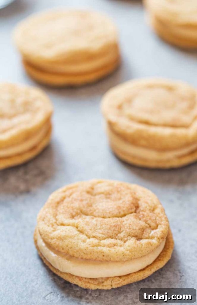 Snickerdoodle cookies perfectly sandwiched together with creamy caramel cream cheese frosting