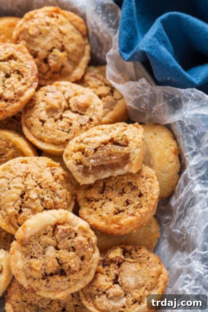 Close-up of freshly baked Pecan Tassies on a cooling rack