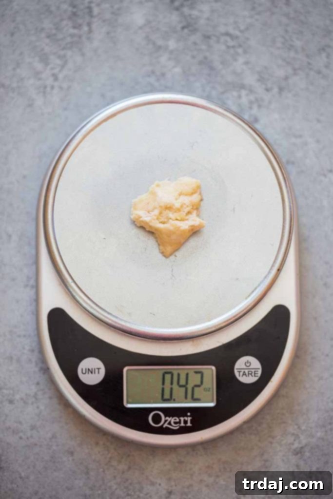Weighing pecan tassie dough on a food scale for even portions