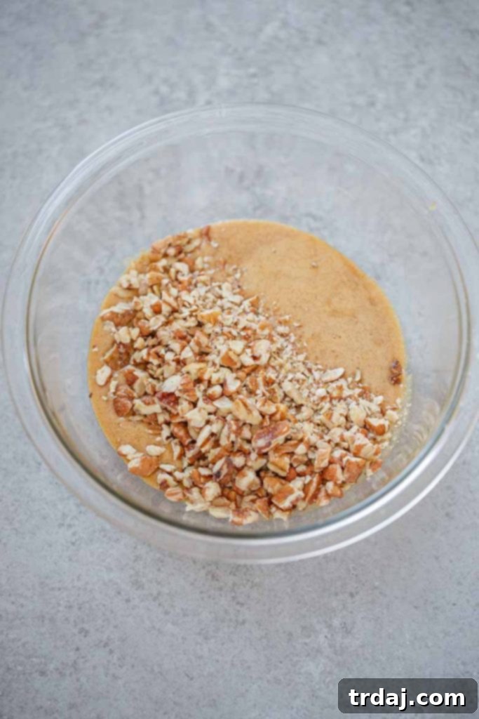 Mixing the pecan tassie filling with brown sugar, pecans, and butter