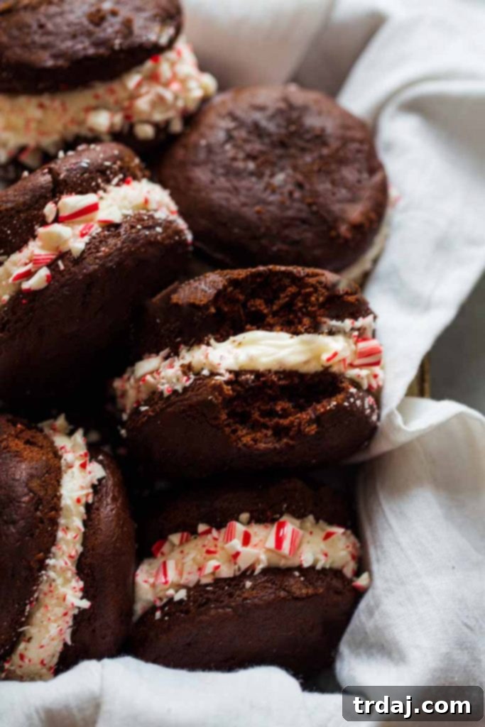 Decadent chocolate mini cakes with peppermint marshmallow buttercream and candy cane pieces Close-up of a Candy Cane Whoopie Pie showing the thick peppermint frosting and candy cane bits