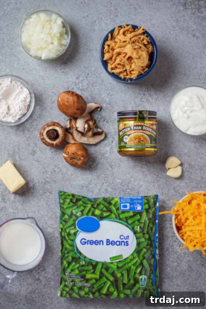 A beautiful spread of fresh ingredients laid out for making easy green bean casserole from scratch, including green beans, mushrooms, onions, garlic, butter, and seasonings.