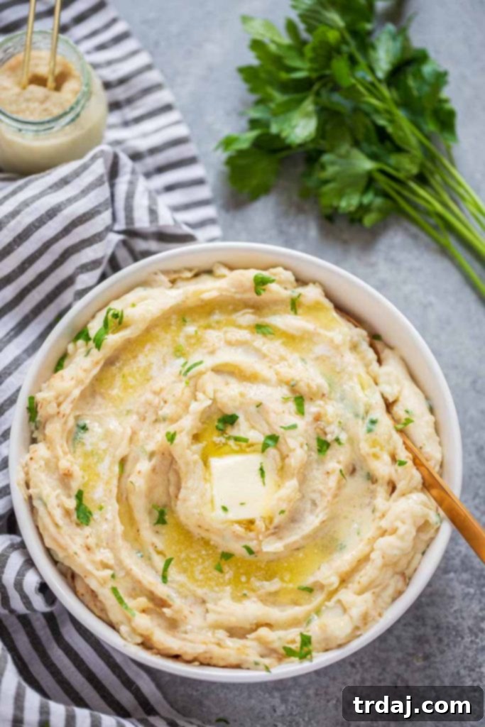 Bowl of ultra-creamy Instant Pot Horseradish Mashed Potatoes, garnished with fresh parsley, ready to serve.