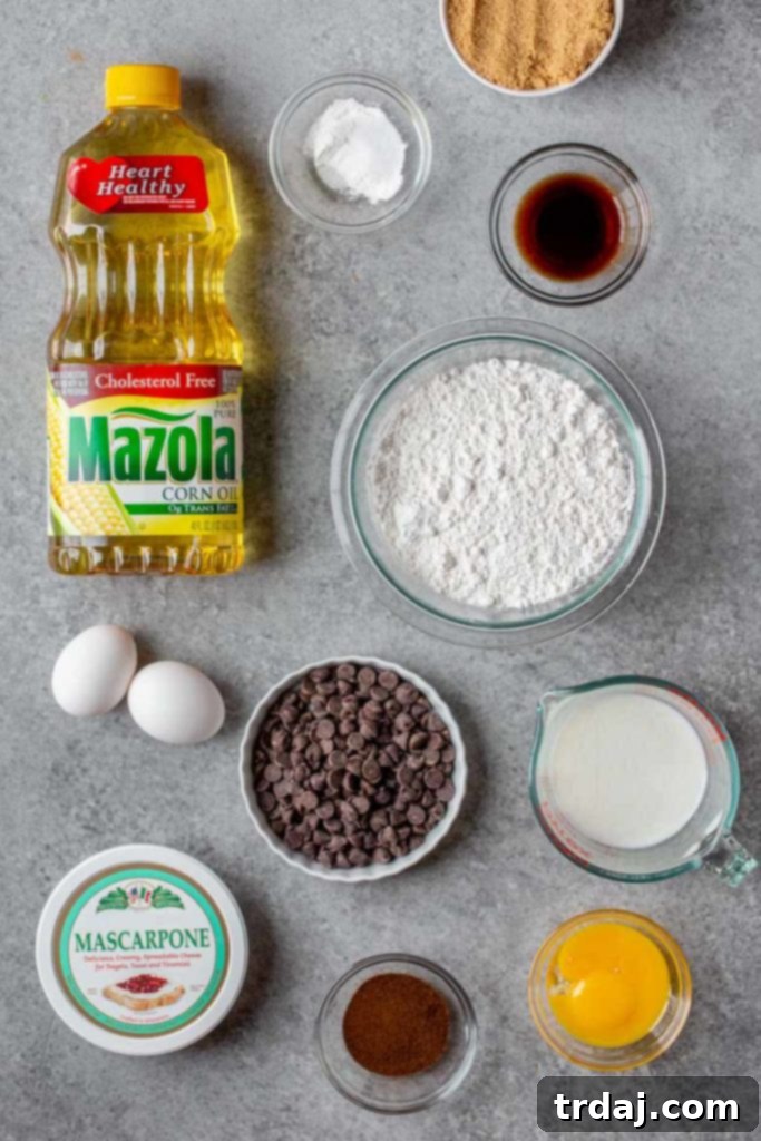 Tiramisu Marble Cake features a vanilla mascarpone cake swirled together with an espresso chocolate cake to create the ultimate Italian coffee lovers dessert! Assortment of Tiramisu Marble Cake ingredients