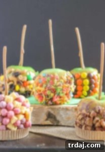 Homemade Caramel Apples with various toppings on a white plate