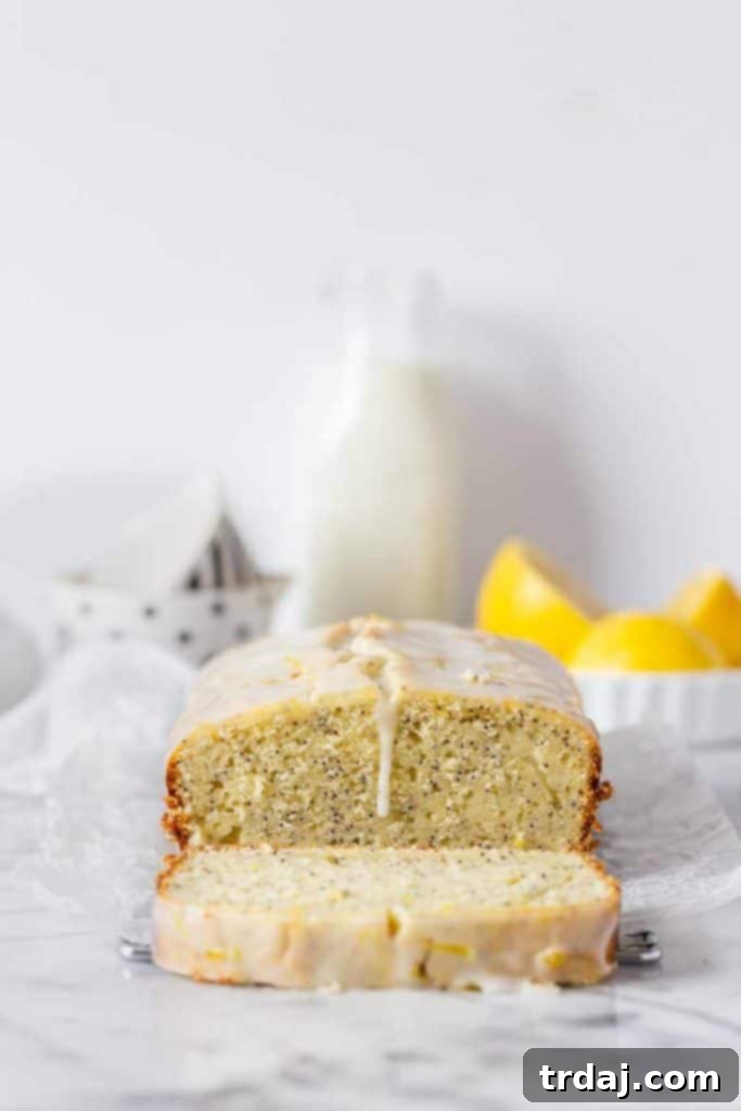 Straight-on view of a magnificent Lemon Poppy Seed Loaf with Glaze, perfectly sliced and arranged, highlighting its beautiful presentation and delicious appeal.
