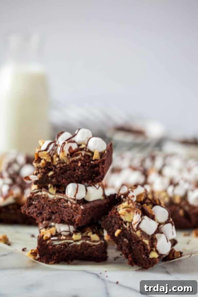A stack of freshly baked Mocha Mint Mississippi Mud Brownies, highlighting their tempting layers and inviting texture.