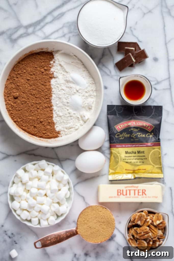 All the fresh ingredients laid out for preparing Mocha Mint Mississippi Mud Brownies, including flour, sugars, cocoa, butter, coffee, mints, pecans, and marshmallows.