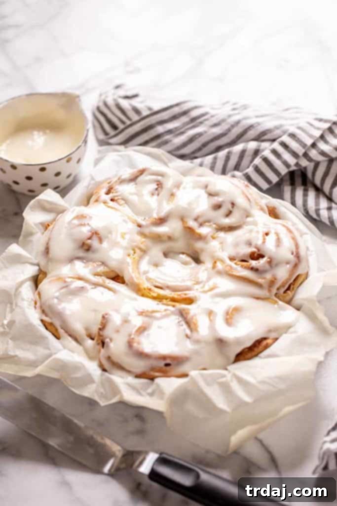 Large image of a plate with Carrot Cake Cinnamon Rolls and coffee