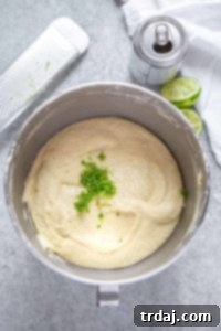 Inside mixing bowl of raspberry Moscow Mule cupcake batter with lime zest