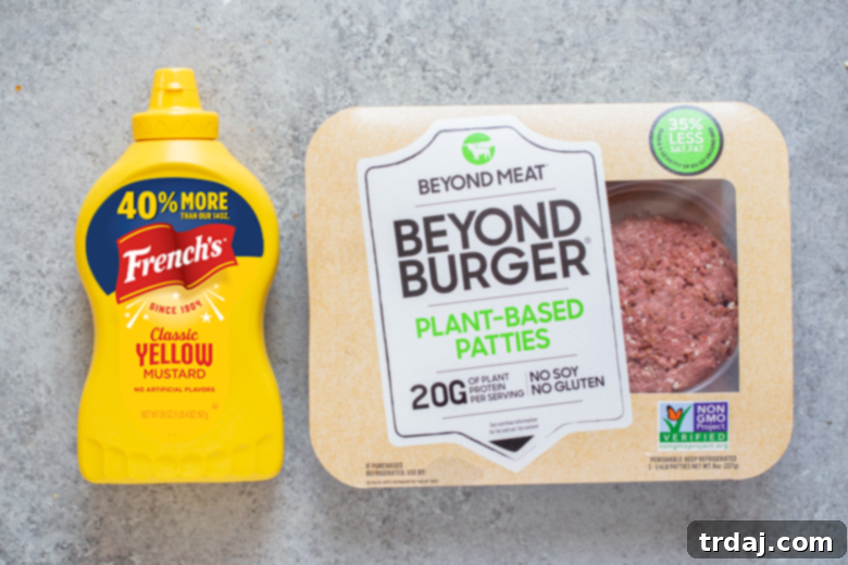 Signature Chicago Beyond Burger 11 A bottle of French's Yellow Mustard positioned next to a package of Beyond Meat Burger plant-based patties, highlighting the key ingredients for a Chicago Style Beyond Burger.