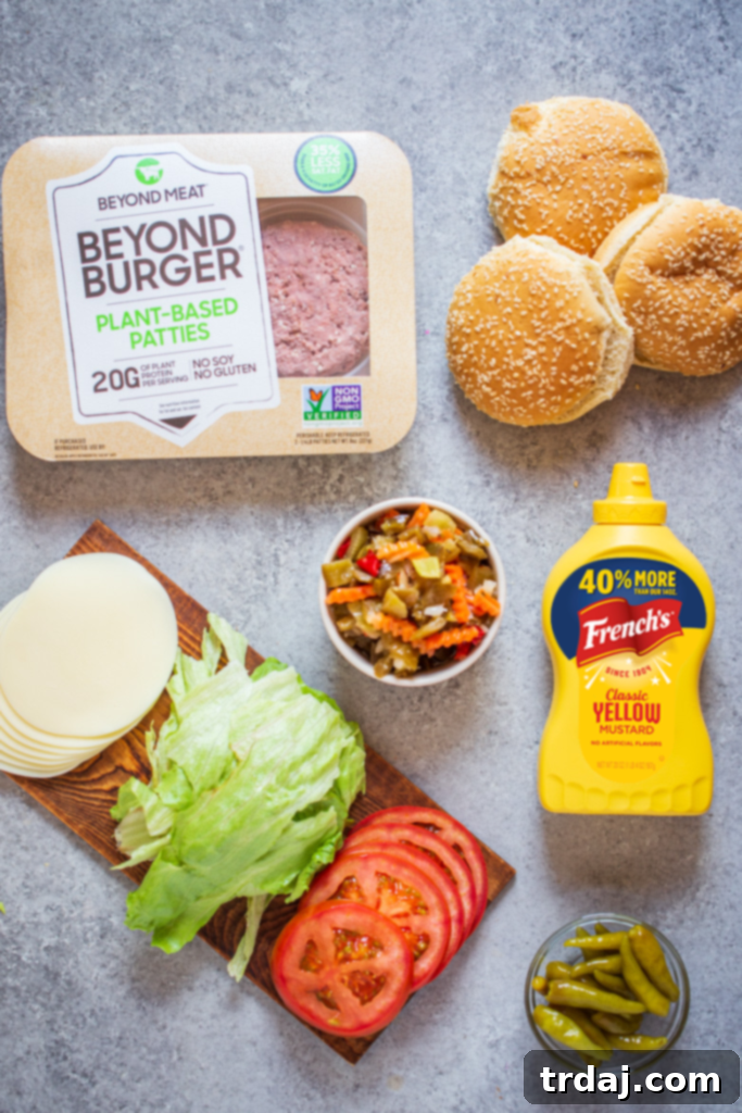 Signature Chicago Beyond Burger 5 A detailed flat lay photograph of all ingredients required to prepare Chicago Style Beyond Burgers, including Beyond Meat patties, French's mustard, giardiniera, provolone cheese, tomatoes, lettuce, and sport peppers.