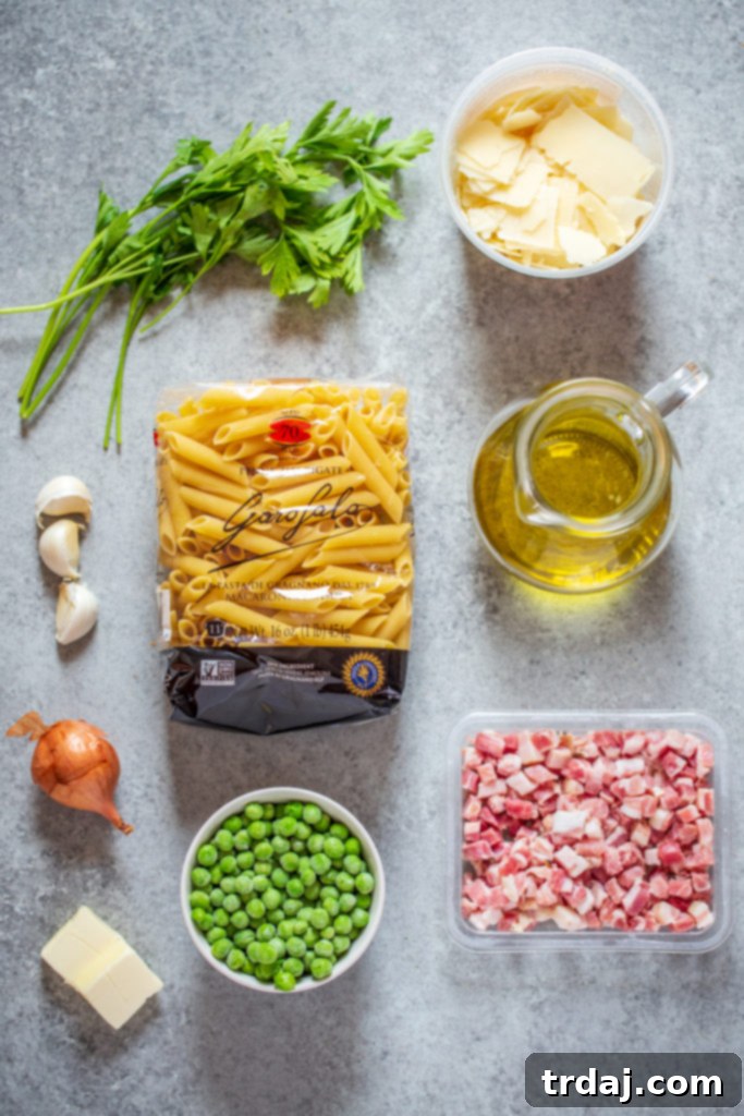 Ingredients for Crispy Pancetta and Sweet Pea Ziti laid out on a kitchen counter.