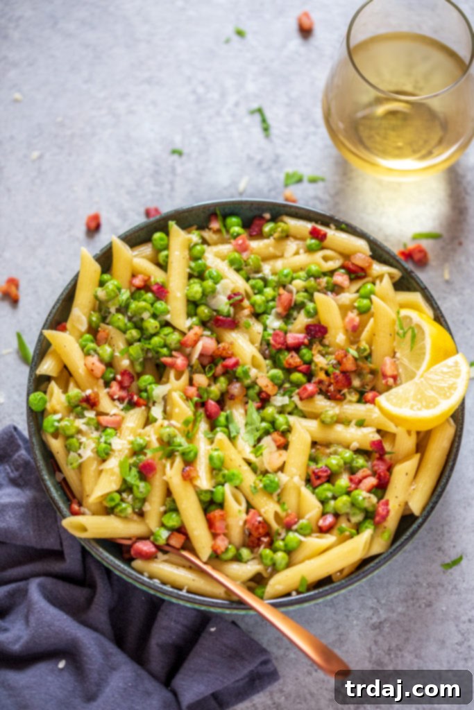 A serving of Crispy Pancetta and Sweet Pea Ziti on a plate, ready to be eaten.
