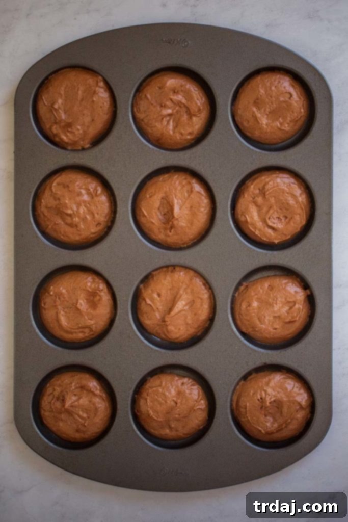Freshly baked chocolate whoopie pie cakes cooling on a wire rack after being removed from the oven