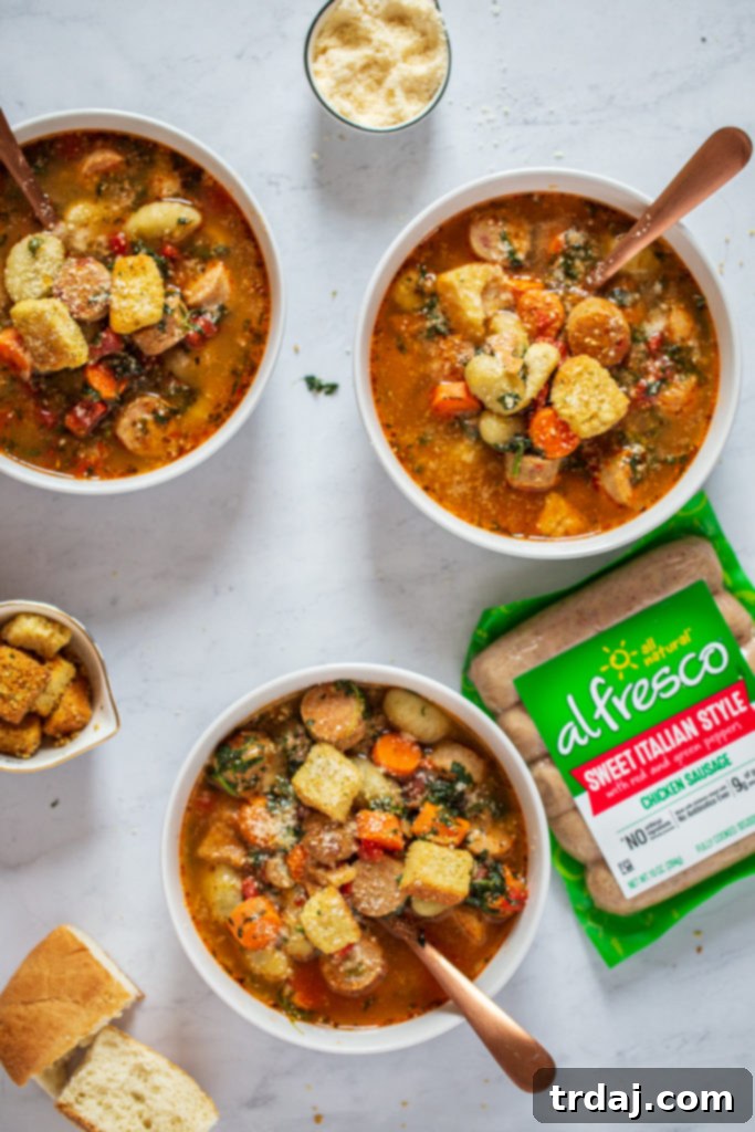 Italian Chicken Gnocchi Soup in bowls with slices of al fresco Sweet Italian chicken sausage