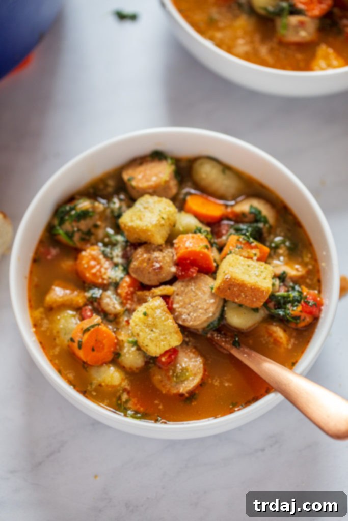Close-up view of a steaming bowl of Italian Chicken Gnocchi Soup