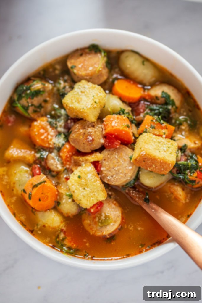 Close-up shot of a full bowl of Italian Chicken Gnocchi Soup with steam rising