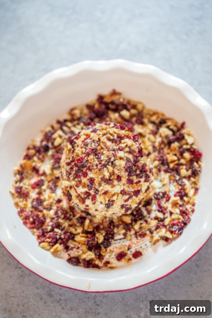 Cranberry Orange Pecan Cheeseball rolled in chopped cranberries and pecans