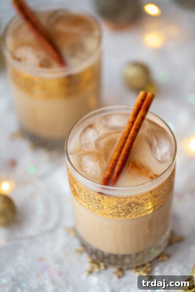 Overhead shot of oatmeal cookie white russian cocktail recipe with cinnamon sticks in gold leaf rocks glasses