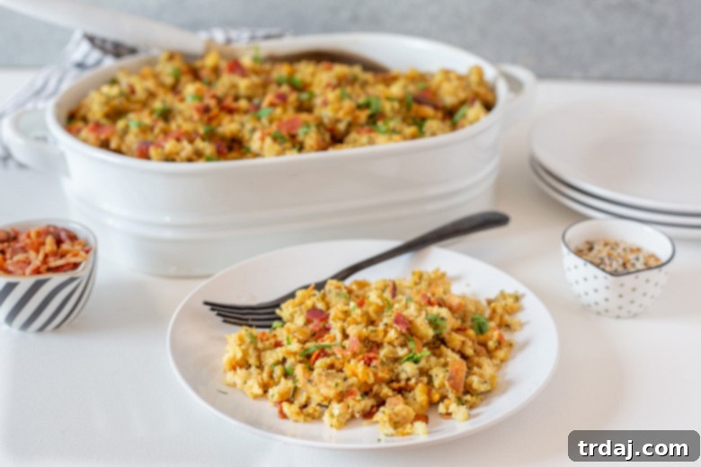 Plated serving of Cheesy Bacon and Everything Stuffing, showcasing the golden-brown crust and melted cheese