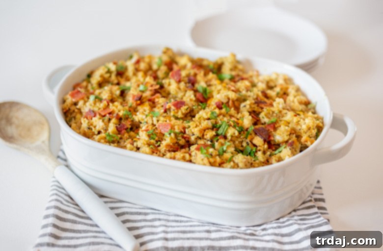 Close-up of Cheesy Bacon and Everything Stuffing in a dish, with crispy bacon bits and melted cheese visible