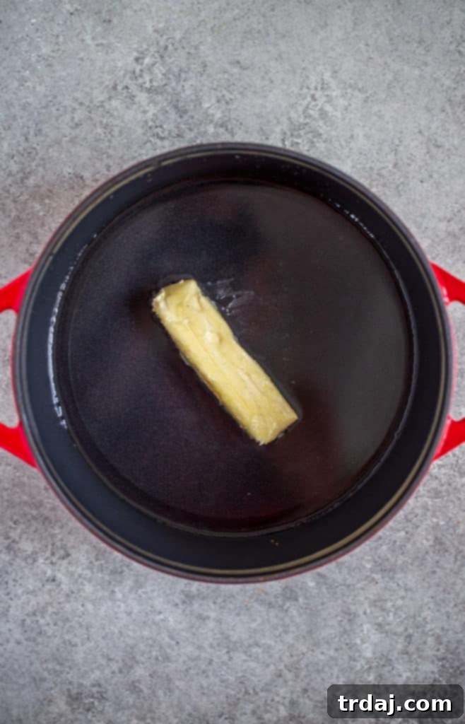Water and butter simmering in a saucepan, beginning the stuffing preparation