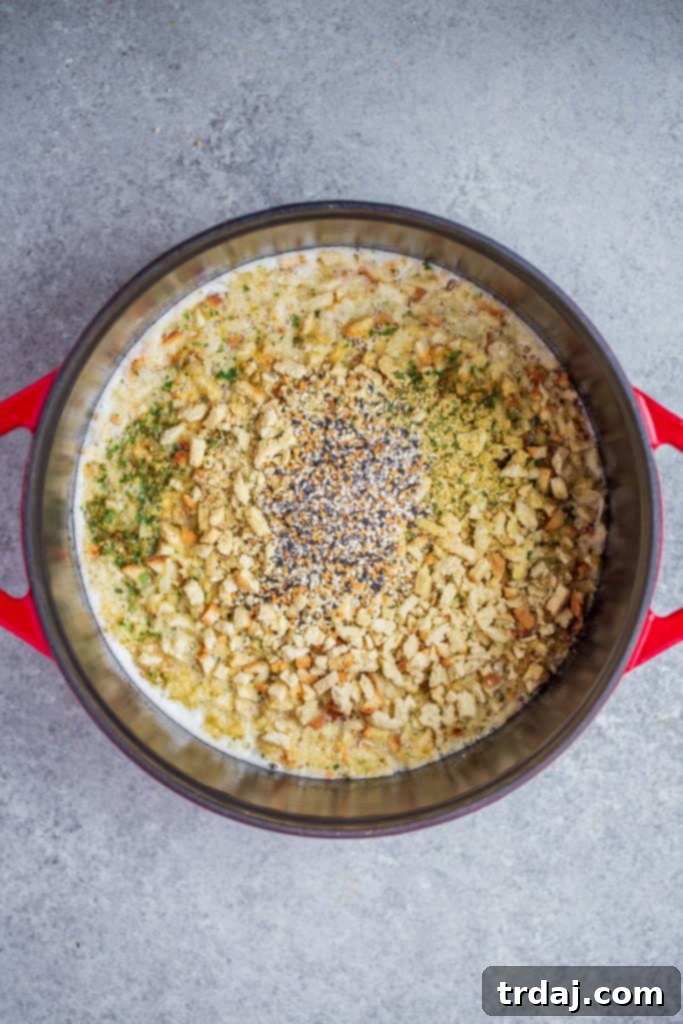 Stuffing mix and everything bagel seasoning being stirred into boiling water and butter, then covered