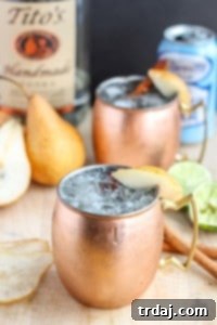 The perfect fall cocktail, this Spiced Pear Moscow Mule features spiced pear simple syrup, vodka, lime and ginger beer. It'll have you enjoying the flavors of Autumn sip after sip. | Strawberry Blondie Kitchen