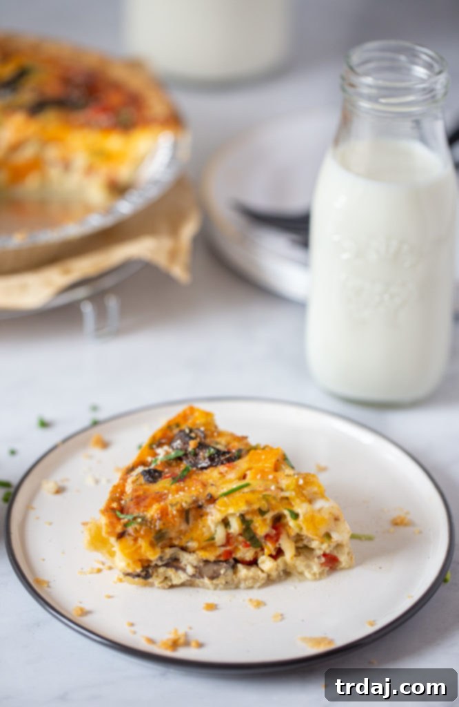 Side shot of a single slice of vegetable quiche with a bottle of milk, embodying a perfect breakfast scene.