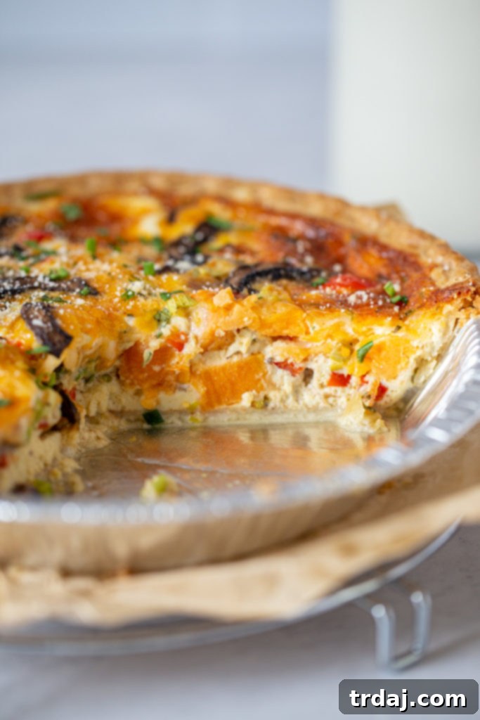Inside shot showing the rich, colorful filling and all the vegetables nestled within the vegetable quiche, a truly satisfying dish.