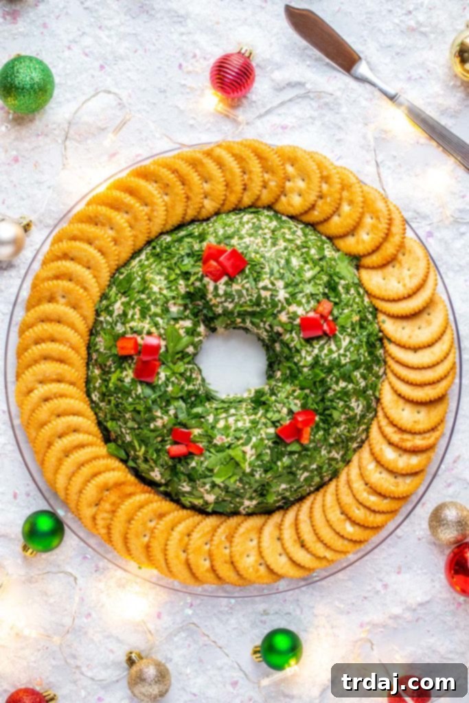 A festive Bacon Cheese Ball Wreath on a platter, adorned with tiny ornaments and sparkling string lights for a holiday presentation.